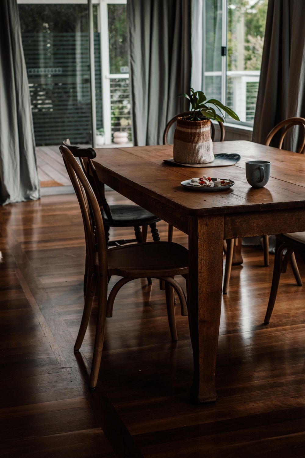 Wooden dining furniture in a warm, thoughtfully arranged room